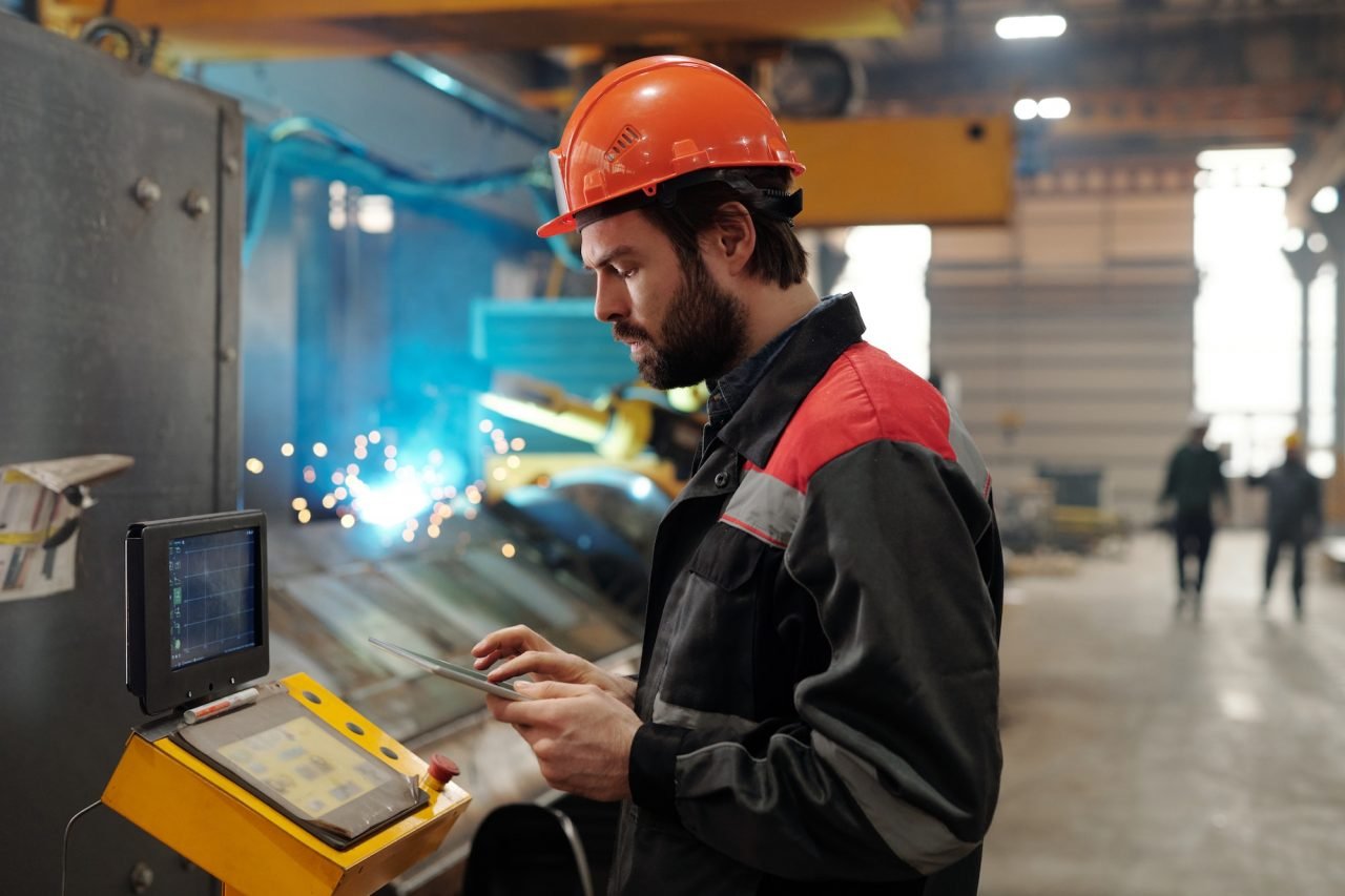 side-view-of-young-engineer-in-workwear-using-digital-tablet.jpg